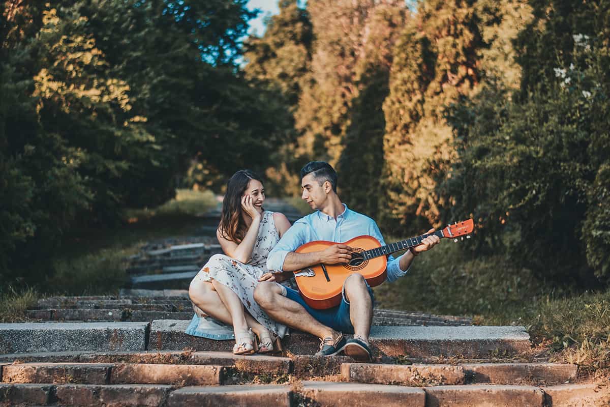 Young Couple Walking In A Romantic Mood With Guitar Outdoors In A Park.  Stock Photo, Picture and Royalty Free Image. Image 90798160.
