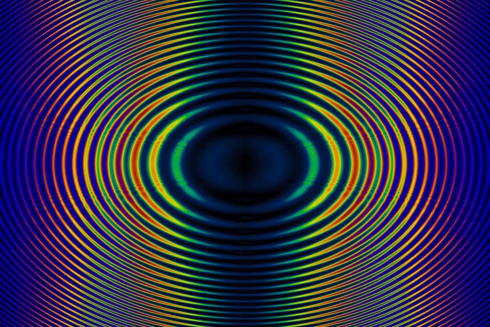 Close-up of light scattering through a prism, the separated colors forming  an abstract, radiant background